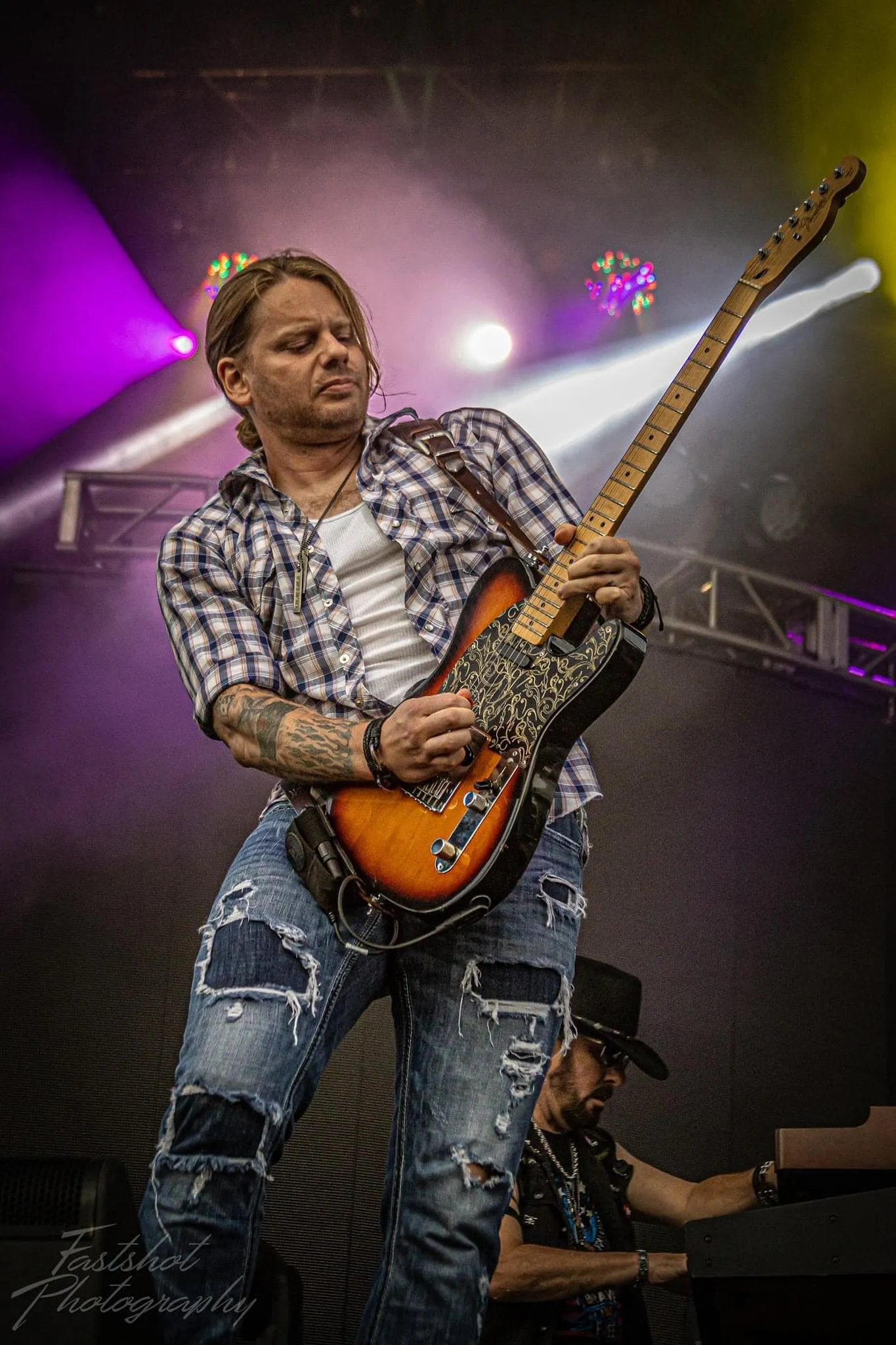 Jason Haven playing guitar at a Ron Keel show