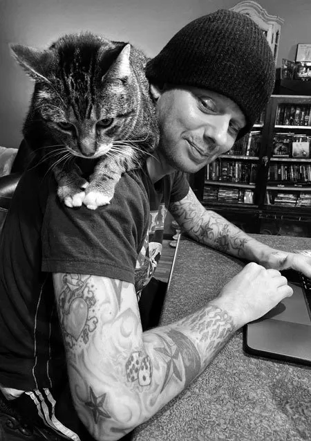 Jason Haven working on a website with his cat on his shoulders
